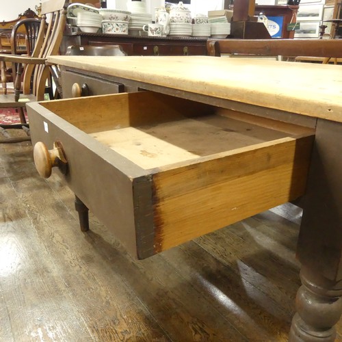 532 - A rustic pine farmhouse Kitchen Table, with two frieze drawers, all raised on turned legs, W 137cm x... 