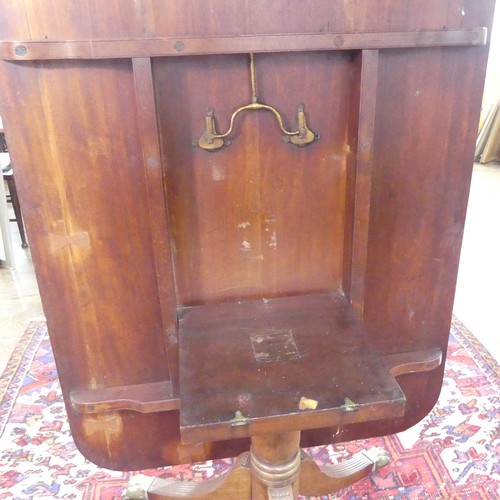 514 - A Georgian mahogany tilt-top Dining Table, the rounded rectangular top with inlaid arrows to corners... 