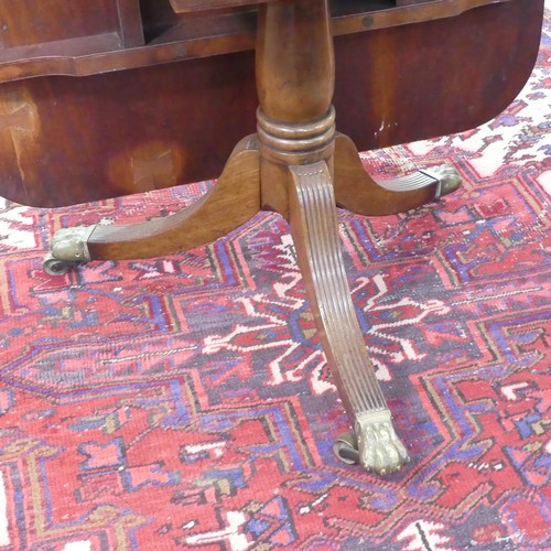 514 - A Georgian mahogany tilt-top Dining Table, the rounded rectangular top with inlaid arrows to corners... 