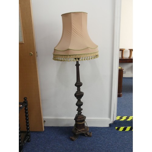 323 - An early 20thC continental carved walnut Standard Lamp, with triangular shaped balusters, raised on ... 