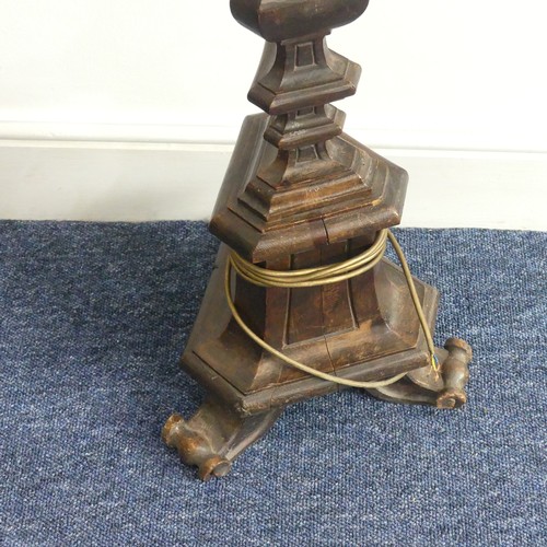 323 - An early 20thC continental carved walnut Standard Lamp, with triangular shaped balusters, raised on ... 