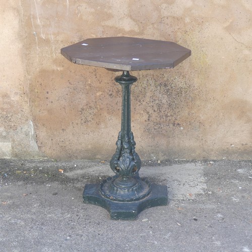 280 - Garden Statuary; An antique cast iron Garden Table, the wooden hexagonal top upon green-painted leaf... 