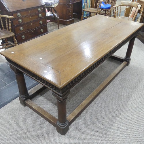 463 - An antique oak Refectory Table, the rectangular top raised above a carved frieze, all raised upon tu... 