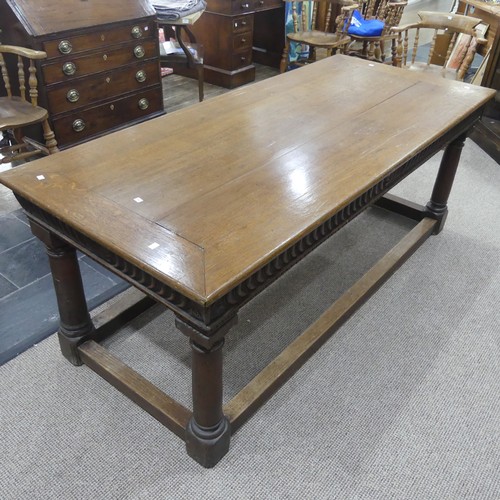 463 - An antique oak Refectory Table, the rectangular top raised above a carved frieze, all raised upon tu... 