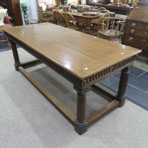 463 - An antique oak Refectory Table, the rectangular top raised above a carved frieze, all raised upon tu... 