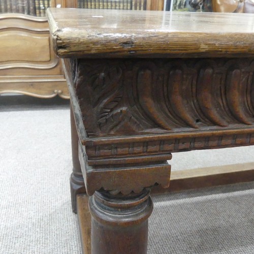 463 - An antique oak Refectory Table, the rectangular top raised above a carved frieze, all raised upon tu... 