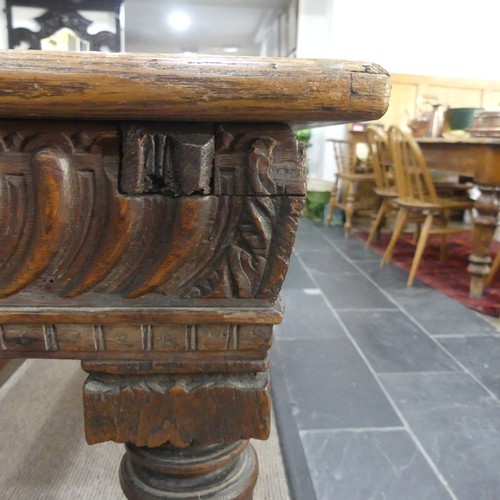 463 - An antique oak Refectory Table, the rectangular top raised above a carved frieze, all raised upon tu... 