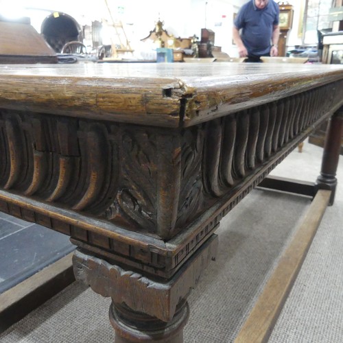 463 - An antique oak Refectory Table, the rectangular top raised above a carved frieze, all raised upon tu... 