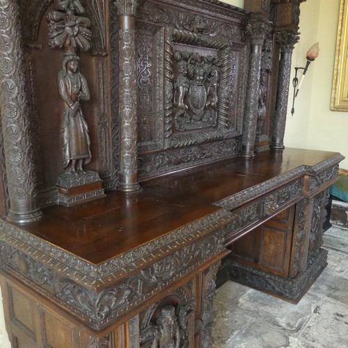 530 - A late 16thC to early 17thC, and later, heavily carved oak large inverted breakfront pedestal Sidebo... 