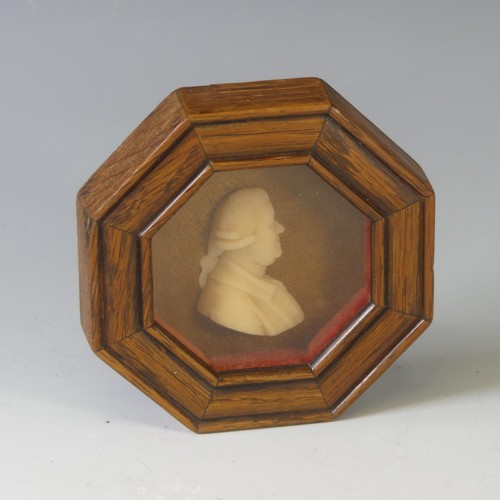 150 - A Georgian wax portrait Plaque of a Gentleman, in an octagonal wood frame, overall frame dimensions ... 