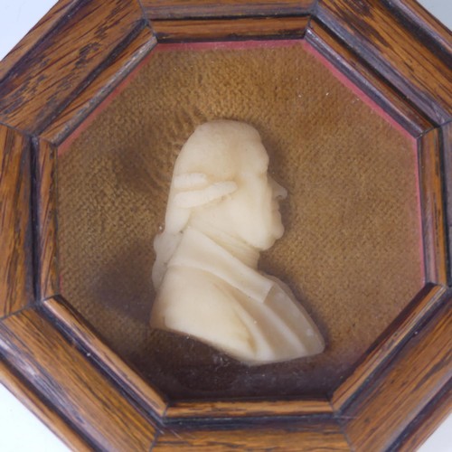 150 - A Georgian wax portrait Plaque of a Gentleman, in an octagonal wood frame, overall frame dimensions ... 