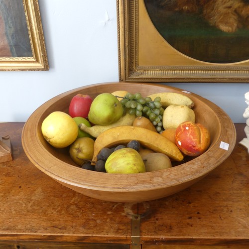 554 - An antique treen turned wood Fruit Bowl, 45cm diameter, together with a quantity of ornamental fruit... 