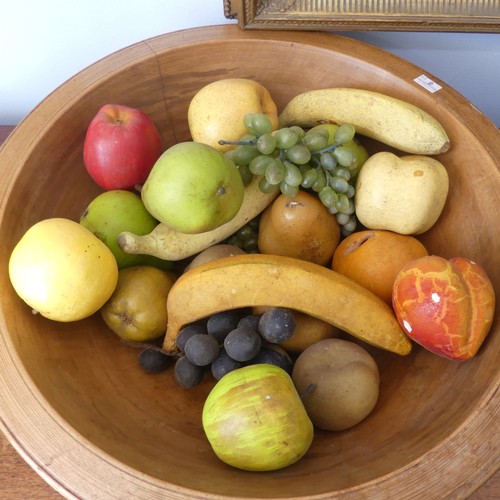 554 - An antique treen turned wood Fruit Bowl, 45cm diameter, together with a quantity of ornamental fruit... 