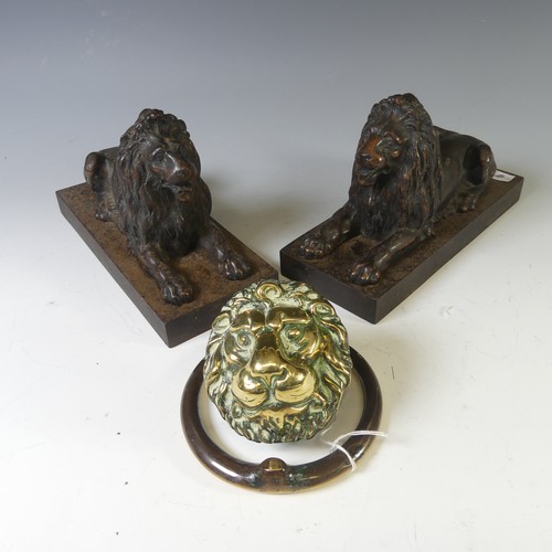 556 - A pair of antique cast metal Fire Dogs, modelled as recumbent Lions, raised on plinth base, W 10cm x... 