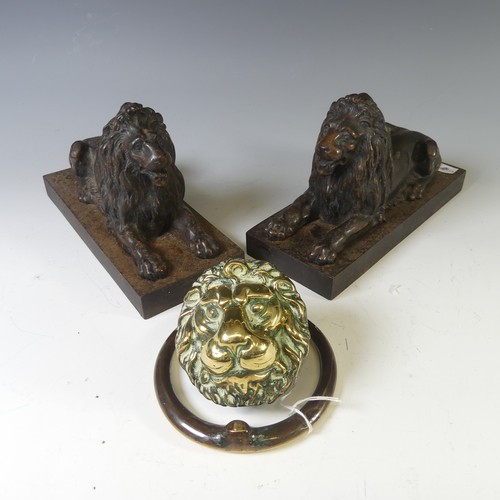 556 - A pair of antique cast metal Fire Dogs, modelled as recumbent Lions, raised on plinth base, W 10cm x... 