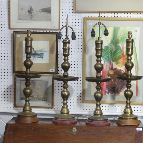 497 -  A pair of heavy Oriental turned brass Table Lamps, with bobbin turned shafts, drip trays and circul... 