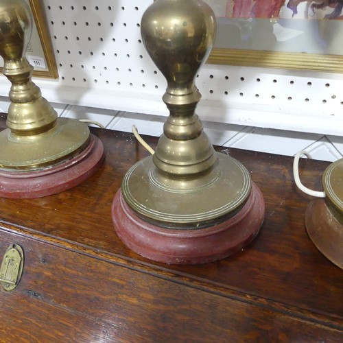 497 -  A pair of heavy Oriental turned brass Table Lamps, with bobbin turned shafts, drip trays and circul... 