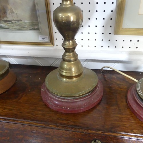 497 -  A pair of heavy Oriental turned brass Table Lamps, with bobbin turned shafts, drip trays and circul... 