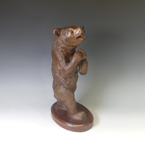 551 - An early 20thC Black Forest carved wooden Standing Bear, naturistically carved with glass eyes, moun... 