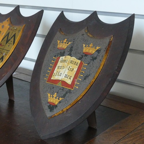 330 - Huyshe Family / Oxford University, a pair of metal shield-shaped coats of arms, on corresponding oak... 