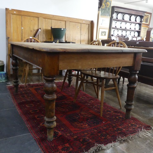 462 - A large late 19th/early 20thC pine plank top Kitchen Table, the rectangular top with rounded corners... 