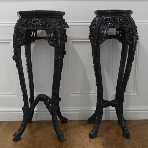 548 - A matched pair of early 20thC of Chinese carved hardwood Plant Stands, one with octagonal pink marbl... 