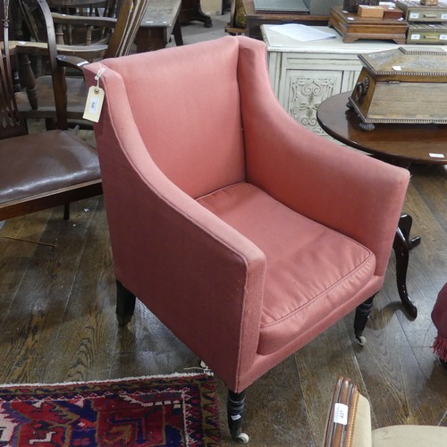 549 - An Edwardian upholstered Armchair, of square shape, in pink upholstery, raised on turned legs and ca... 