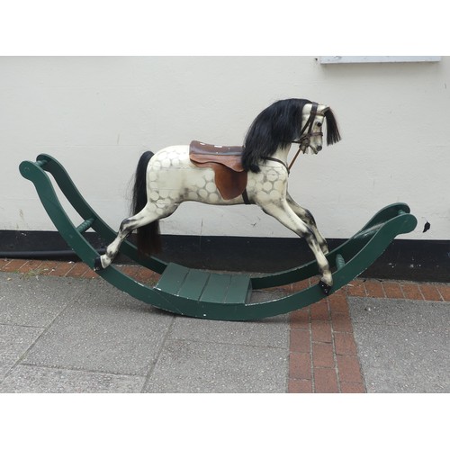 507 - An early 20thC grey dapple painted Rocking Horse, with mane, leather saddle and tack, on wooden rock... 