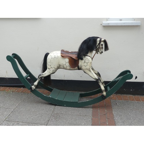 507 - An early 20thC grey dapple painted Rocking Horse, with mane, leather saddle and tack, on wooden rock... 