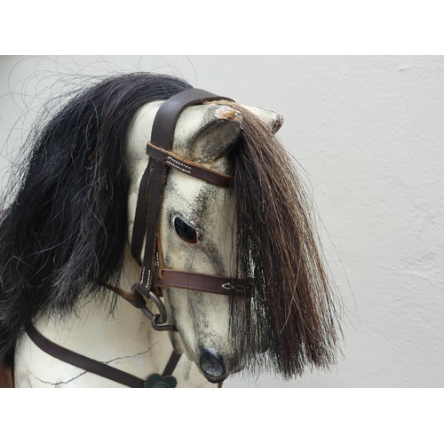 507 - An early 20thC grey dapple painted Rocking Horse, with mane, leather saddle and tack, on wooden rock... 