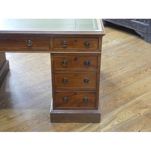 531 - An Edwardian twin Pedestal desk, the rectangular top inset with tooled green skiver, above three fri... 