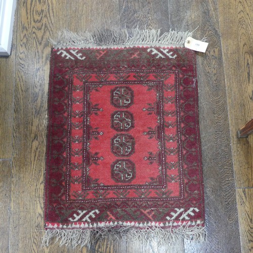 601 - Tribal rugs; a small red ground wool Afghan Mat, together with a machine made hanging (2)... 