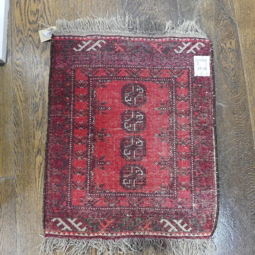 601 - Tribal rugs; a small red ground wool Afghan Mat, together with a machine made hanging (2)... 