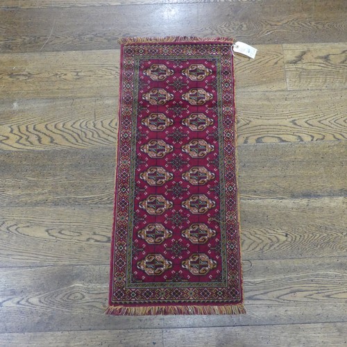 601 - Tribal rugs; a small red ground wool Afghan Mat, together with a machine made hanging (2)... 