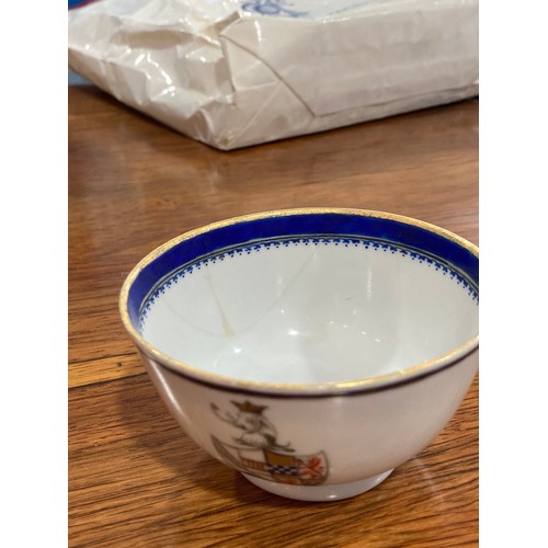 144 - An 18thC Chinese export armorial porcelain Teabowl and Saucer, decorated with gilt and blue banding ... 