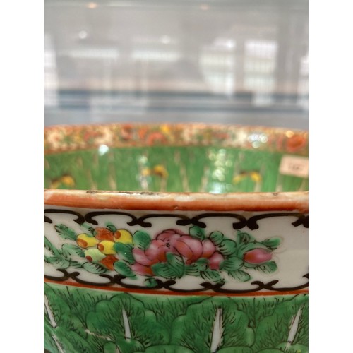 142 - A late 19thC Cantonese famille verte porcelain Punch Bowl, the rim decorated with flora and fauna in... 