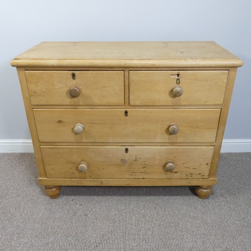 An antique pine Chest of Drawers, two short and two long drawers on bun