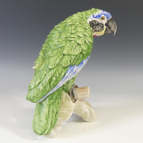 495 - A Goebel porcelain figure of a Parrot, modelled perched on a stump, factory marks to base, H 21cm, t... 