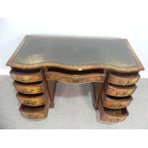 565 - An early 20thC walnut Serpentine-fronted Pedestal Desk, the top with green tooled leatherette inset,... 