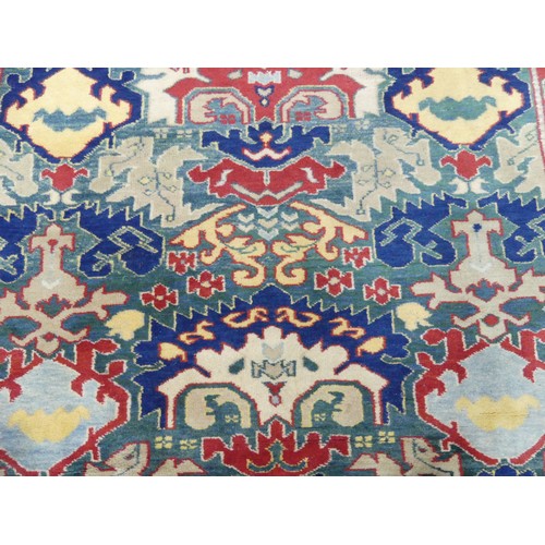 675 - Tribal Rugs: a Turkish hand knotted wool rug, the whole woven with bold geometric patterns in turquo... 