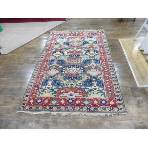 675 - Tribal Rugs: a Turkish hand knotted wool rug, the whole woven with bold geometric patterns in turquo... 