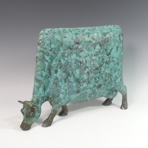 131 - Lawson E. Rudge (b. 1936), a raku fired studio pottery sculpture of a Grazing Cow, with metallic fin... 