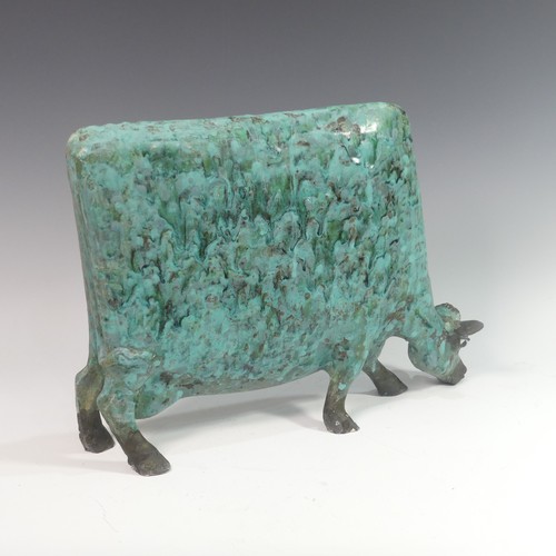 131 - Lawson E. Rudge (b. 1936), a raku fired studio pottery sculpture of a Grazing Cow, with metallic fin... 