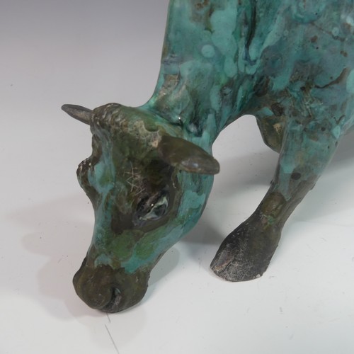 131 - Lawson E. Rudge (b. 1936), a raku fired studio pottery sculpture of a Grazing Cow, with metallic fin... 