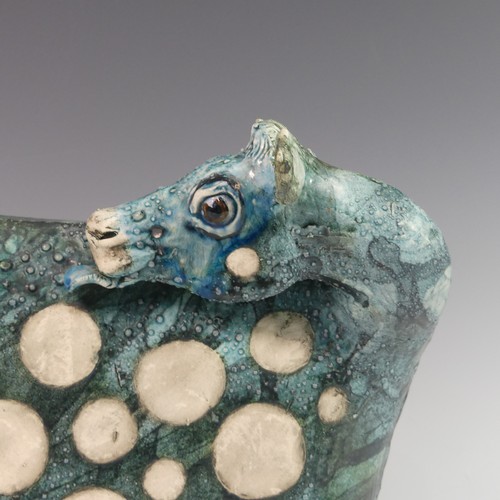 119 - Lawson E. Rudge (b. 1936), a raku fired studio pottery sculpture of a Cow, with textured blue glaze ... 