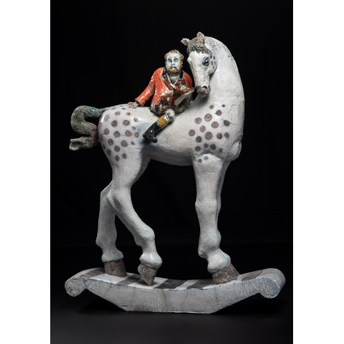 Lawson E. Rudge (b. 1936), a raku fired studio pottery sculpture 'Self Portrait on Horseback', modelled as the artist in hunting uniform with fox on a rocking horse style base, some damages, H 59cm.