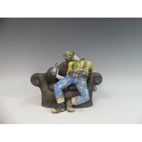 129 - Lawson E. Rudge (b. 1936), a raku fired studio pottery sculpture of a Drunkard on Sofa, H 23cm.Prove... 