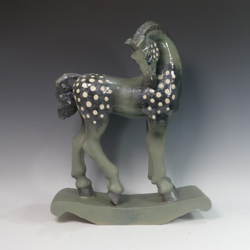 62 - Lawson E. Rudge (b. 1936), a raku fired studio pottery sculpture of a Tang Horse, crack to base and ... 