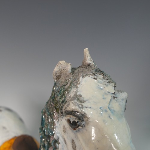 68 - Lawson E. Rudge (b. 1936), a pair of raku fired studio pottery sculptures of Carousel Horses, one wi... 