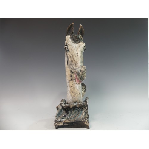 71 - Lawson E. Rudge (b. 1936), a raku fired studio pottery sculpture of a Horse Head, modelled on a wave... 